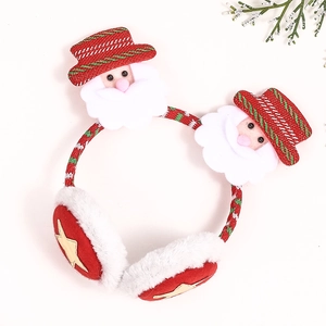 Close-up of festive Christmas earmuffs featuring plush Santa motifs and gold star details