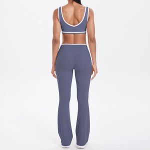 Rear view of dusty blue two-piece yoga set featuring cross back bra and flared yoga pants
