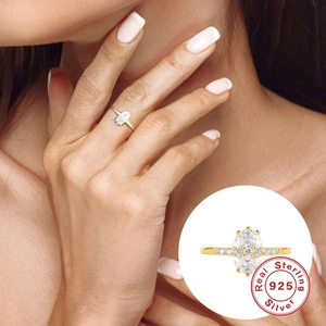 Golden S925 sterling silver wedding ring with oval diamond on model finger