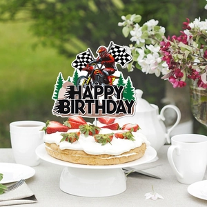 Dirt bike birthday cake topper with rider and checkered flags on strawberry cake