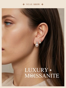 Close-up of elegant S925 silver stud earring with moissanite and pearl on a model's ear