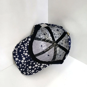 Internal view of navy cotton baseball cap with white stars and 100% cotton wash label