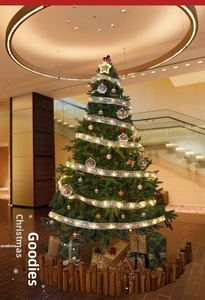 Close-up of golden LED ribbon lights glowing on a decorated Christmas tree set