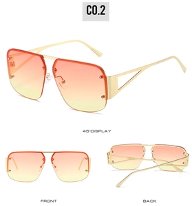 Detail view of square rimless sunglasses with orange gradient lenses and gold frames