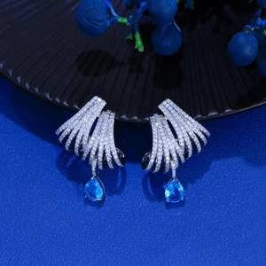 Close-up of S925 silver needle earrings with blue teardrop gems and white zircon inlay