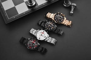 Collection of VIGANO men's chronograph watches with metal straps on a luxury chessboard