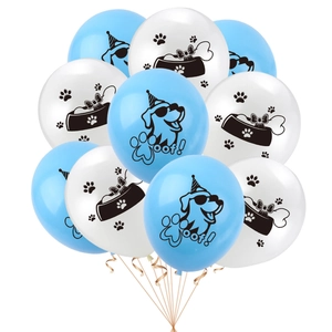 Close-up of blue and white latex balloons with dog illustrations and Woof text for pet party