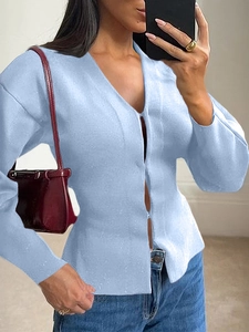 Close-up of soft light blue knit cardigan with V-neckline and button-down front details