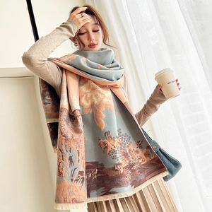Detailed close-up of a thick cashmere-like scarf with landscape painting and fringe edge