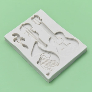 Light grey musical instrument silicone mold featuring guitar and violin for cake decorating