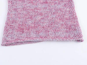 Detailed macro view of the soft pink and light blue gradient knit fabric texture