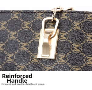 Detail of brown monogram handbag with reinforced gold hardware and M-pattern faux leather