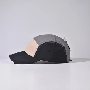 Detail of color-block baseball cap showing breathable holes and lightweight fabric
