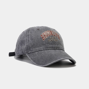 Detail of red Brooklyn letter embroidery on vintage washed cotton baseball cap texture