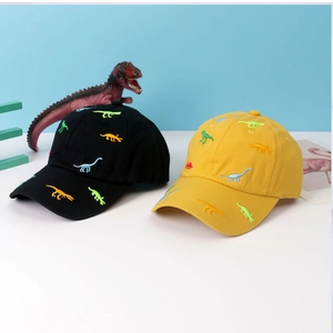 Close-up of black and yellow baseball caps with colorful dinosaur embroidery details