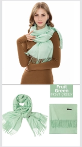 Detail view of fruit green cashmere scarf with tassel fringe and product labels