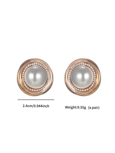 Close-up of pearl earrings with rose gold spiral frame and cubic zirconia stones