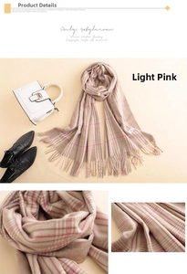 Detail shot of light pink plaid cashmere scarf with soft tassels and woven texture
