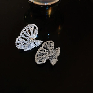 Macro shot of silver butterfly earrings featuring sparkling zircon stone settings
