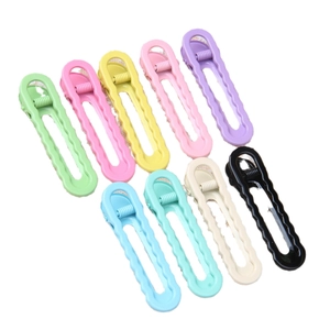 Set of 9 colorful 6cm glossy wave hair clips in macaron colors on a white background