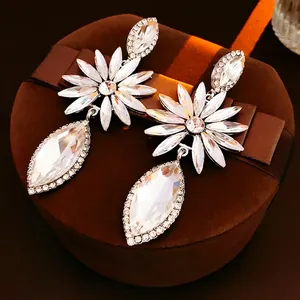 Exaggerated silver needle floral drop earrings with sparkling teardrop crystals