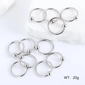 Set of silver stainless steel captive bead rings on white stone background with 20g weight