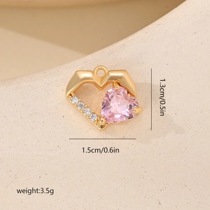 Macro detail of a pink zircon heart pendant in gold setting with size and weight labels
