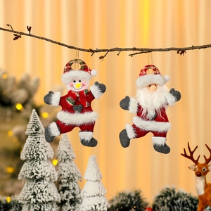 Plush Santa and Snowman hanging ornaments on Christmas tree branch decoration