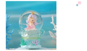 Macro shot of mermaid crystal ball with purple hair princess and coral reef base detail