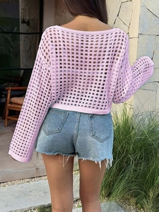 Rear view of women's pink Y2K cut-out knit top with long sleeves for a trendy summer look