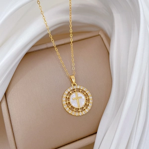 Titanium steel round cross necklace with mother of pearl and crystals on silk background