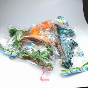 Detail of assorted wind-up dinosaur toys in individual retail packaging with hang cards