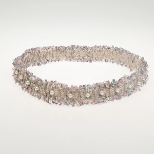 Detail of pink and gray woven fabric headband with faux pearls and golden threads