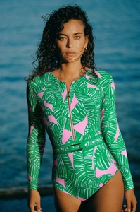 Detail of long-sleeve surf swimsuit featuring green tropical print and front zipper closure