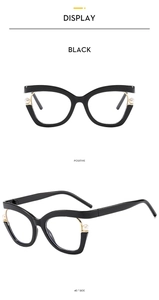 Detail of black cat-eye glasses frame featuring elegant white pearl accents and gold metal