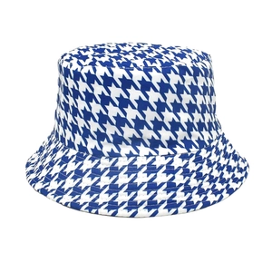 Detail of blue and white houndstooth pattern fabric on a stylish cotton bucket hat