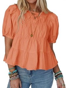 Orange bubble sleeve babydoll blouse with tiered pleated hem and bohemian casual style