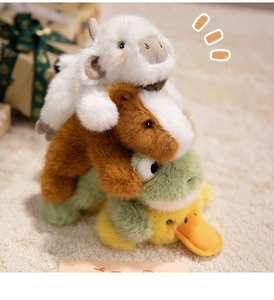 Close-up of cute plush animal stack including cow capybara frog and duck toys