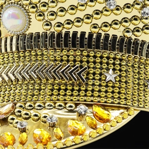 Close-up of gold sequins, rhinestones, and star metal details on a bridal captain hat
