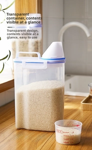 Close-up of clear rice storage container with blue seal lid and graduated measuring cup