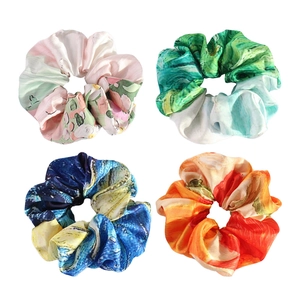 Set of four satin scrunchies with elegant french oil painting patterns on white background