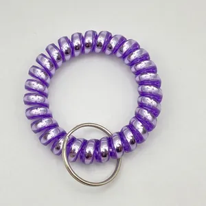 Detail view of purple spiral plastic coil keychain with a silver metal ring
