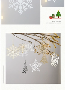Detailed view of silver and gold snowflake reindeer ornaments hanging on tree branches