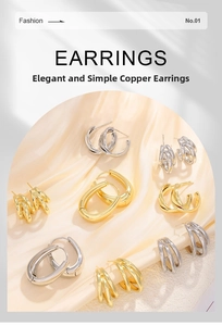 Collection of geometric copper earrings in gold and silver on a silk fabric background