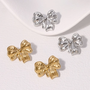 Minimalist bow-knot stud earrings in gold and silver finish on white background