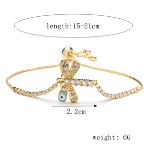 Detail of adjustable gold dragonfly bracelet with zircons and evil eye charm dimensions