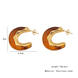 Detail view of irregular C-shaped earrings in amber resin and gold stainless steel