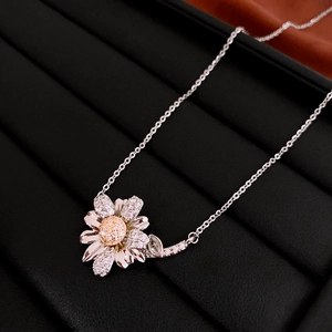 Macro detail of dainty silver daisy flower necklace with zircons on black velvet display