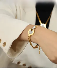 Close-up of gold woven titanium steel bracelet with pavé rhinestones on model's wrist