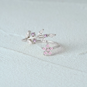 Detailed view of silver leaf and pink floral ring with marquise cubic zirconia stones
